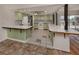 View of kitchen with pale green cabinets and tile flooring at 143 Rotonda Cir, Rotonda West, FL 33947