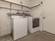 Convenient laundry room with washer, dryer, and overhead shelving at 143 Rotonda Cir, Rotonda West, FL 33947