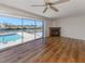 Living room with hardwood floors, fireplace, and sliding glass doors leading to a pool at 143 Rotonda Cir, Rotonda West, FL 33947