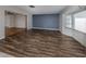 Living room with wood flooring and blue accent wall at 143 Rotonda Cir, Rotonda West, FL 33947