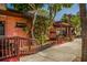 Restaurant patio with seating, lush foliage and wooden pergola at 143 Rotonda Cir, Rotonda West, FL 33947