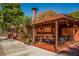 Restaurant patio with tables and chairs under a wooden pergola at 143 Rotonda Cir, Rotonda West, FL 33947