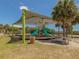 Shaded playground with slides and picnic tables at 143 Rotonda Cir, Rotonda West, FL 33947