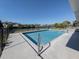 Sparkling clean pool with metal railings and canal view at 143 Rotonda Cir, Rotonda West, FL 33947