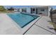 Inviting rectangular pool with a gray concrete deck and fence at 143 Rotonda Cir, Rotonda West, FL 33947