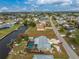 Aerial view showcasing home's pool, large backyard, and canal access at 160 Salem Nw Ave, Port Charlotte, FL 33952