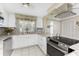 White kitchen with stainless steel appliances and tile backsplash at 160 Salem Nw Ave, Port Charlotte, FL 33952