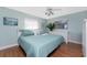 Main bedroom with light teal bedding and wood floors at 160 Salem Nw Ave, Port Charlotte, FL 33952