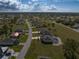 Aerial view of a residential community, showing houses, roads, and open spaces at 16305 Branco Dr, Punta Gorda, FL 33955