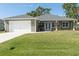 Modern one-story house with attached garage and well-manicured lawn at 16305 Branco Dr, Punta Gorda, FL 33955