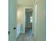 Hallway with white cabinets and wood-look floors at 16305 Branco Dr, Punta Gorda, FL 33955