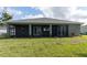 House back view, showcasing a large screened patio and backyard at 16305 Branco Dr, Punta Gorda, FL 33955