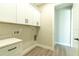 Laundry room with white cabinets and quartz countertop at 16305 Branco Dr, Punta Gorda, FL 33955