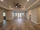 Spacious living room featuring wood-look floors, a ceiling fan, recessed lighting, and multiple windows at 16305 Branco Dr, Punta Gorda, FL 33955