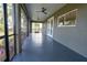 Large screened porch with grey flooring and fans at 16305 Branco Dr, Punta Gorda, FL 33955