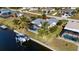 Aerial view of canal-front home with private dock and boat lift at 18170 Avonsdale Cir, Port Charlotte, FL 33948