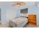 Light and airy bedroom featuring a ceiling fan and built-in shelving at 18170 Avonsdale Cir, Port Charlotte, FL 33948