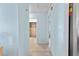 Clean and bright hallway with light blue walls and tile floors at 18170 Avonsdale Cir, Port Charlotte, FL 33948