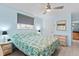 Main bedroom with king-size bed, ceiling fan, and wicker furniture at 18170 Avonsdale Cir, Port Charlotte, FL 33948