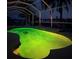 Inviting pool at night with green illuminating lights at 18170 Avonsdale Cir, Port Charlotte, FL 33948