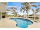 Relaxing pool area with canal views and palm trees at 18170 Avonsdale Cir, Port Charlotte, FL 33948