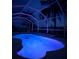 Luminous nighttime pool view with colorful lighting at 18170 Avonsdale Cir, Port Charlotte, FL 33948