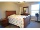 Bedroom with wooden bed frame and floral bedding at 1999 Kings Hwy # 23C, Punta Gorda, FL 33980