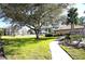 Landscaped lawn with walkway and trees at 1999 Kings Hwy # 23C, Punta Gorda, FL 33980