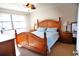 Spacious main bedroom with wooden furniture and large windows at 1999 Kings Hwy # 23C, Punta Gorda, FL 33980