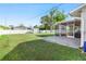 Large grassy backyard with screened patio and storage shed at 20430 Dial Ave, Port Charlotte, FL 33952