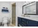 Modern bathroom with navy blue vanity and marble countertop at 20430 Dial Ave, Port Charlotte, FL 33952