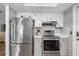 Modern kitchen with stainless steel appliances and white cabinets at 20430 Dial Ave, Port Charlotte, FL 33952