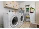 Bright laundry room with washer, dryer, and storage at 20430 Dial Ave, Port Charlotte, FL 33952