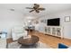 Living room with hardwood floors, white furniture, and a large TV at 20430 Dial Ave, Port Charlotte, FL 33952