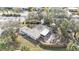 Aerial view of a single-story house with a large yard and lanai at 21190 Midway Blvd, Port Charlotte, FL 33952