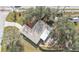 Aerial view of a single-story house with a large yard and lanai at 21190 Midway Blvd, Port Charlotte, FL 33952