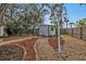 Landscaped backyard with shed and defined pathways at 21190 Midway Blvd, Port Charlotte, FL 33952