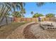 Large backyard with gravel landscaping, fire pit, and wooden fence at 21190 Midway Blvd, Port Charlotte, FL 33952