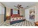 Bright bedroom with a king bed, dresser, and view of kitchen at 21190 Midway Blvd, Port Charlotte, FL 33952