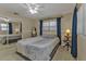 Bedroom featuring a double bed, mirrored closet, and fan at 21190 Midway Blvd, Port Charlotte, FL 33952