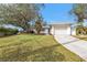 White single-story home with attached garage and manicured lawn at 21190 Midway Blvd, Port Charlotte, FL 33952