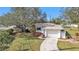 Single story home with attached garage and landscaped yard at 21190 Midway Blvd, Port Charlotte, FL 33952