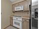 Clean kitchen with white appliances and wood cabinets at 21190 Midway Blvd, Port Charlotte, FL 33952