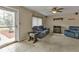 Living room with blue reclining sofa and electric fireplace at 21190 Midway Blvd, Port Charlotte, FL 33952