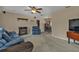 Bright living room featuring comfy blue sofas and a fireplace at 21190 Midway Blvd, Port Charlotte, FL 33952