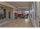 Bright screened-in porch with tile floor and red seating at 21190 Midway Blvd, Port Charlotte, FL 33952