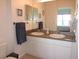 Double vanity bathroom with large mirror and shower at 2180 Heron Lake Dr # K-208, Punta Gorda, FL 33983