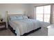 King-size bedroom with large window and striped bedding at 2180 Heron Lake Dr # K-208, Punta Gorda, FL 33983