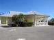 Community clubhouse with covered seating and parking area at 2180 Heron Lake Dr # K-208, Punta Gorda, FL 33983