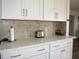 Kitchen counter with quartz countertop and white cabinets at 2180 Heron Lake Dr # K-208, Punta Gorda, FL 33983